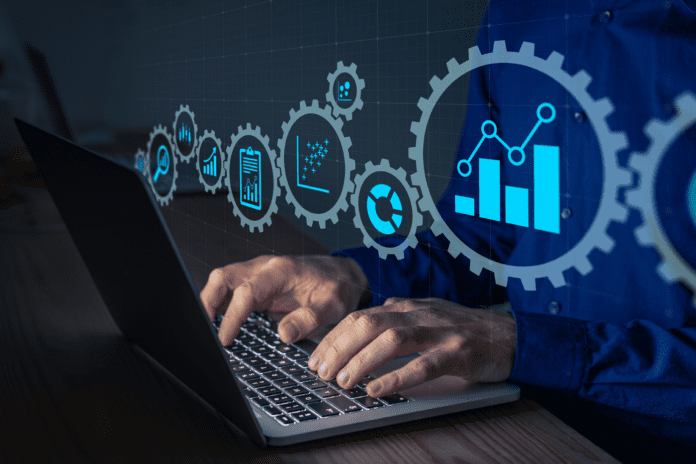 Data science icons on linked gears with a man using a laptop.